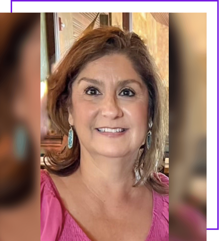 A woman with brown hair and pink shirt smiling.